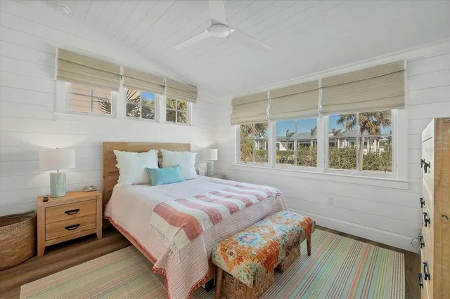 a bedroom with a bed and a large window