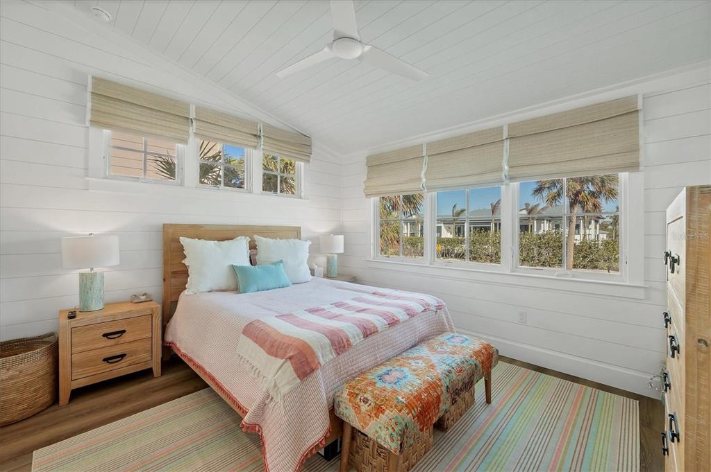 290 Gulf Boulevard, Unit 17 Boca Grande, FL 33921 - Photo 28 of 39 a bedroom with a bed and a large window