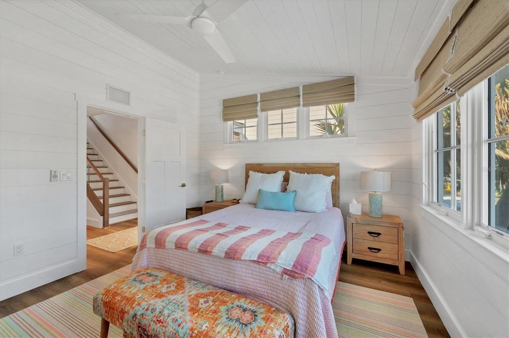 290 Gulf Boulevard, Unit 17 Boca Grande, FL 33921 - Photo 29 of 39 a bedroom with a bed a mirror and a window