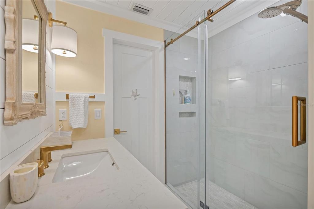 290 Gulf Boulevard, Unit 17 Boca Grande, FL 33921 - Photo 31 of 39 a bathroom with a sink a toilet and shower