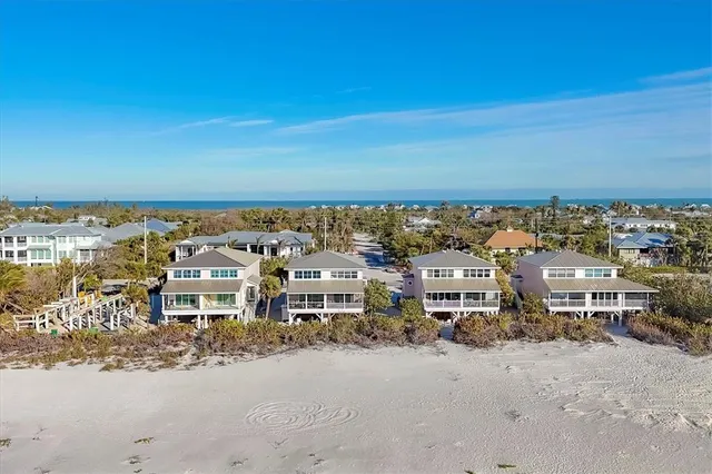 an aerial view of residential houses with city view