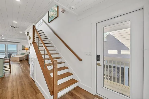 a view of entryway and hall with wooden floor