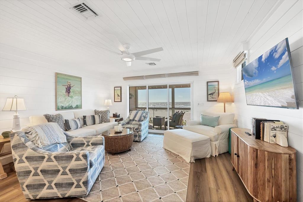 290 Gulf Boulevard, Unit 17 Boca Grande, FL 33921 - Photo 9 of 39 a living room with furniture and a floor to ceiling window