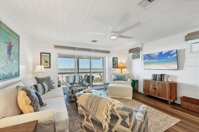 a bedroom with furniture and large windows