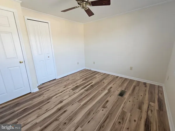a view of a room with wooden floor