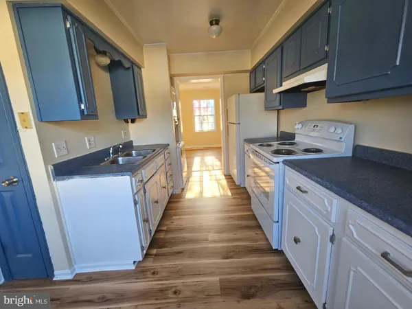 a kitchen with stainless steel appliances granite countertop a stove and a sink