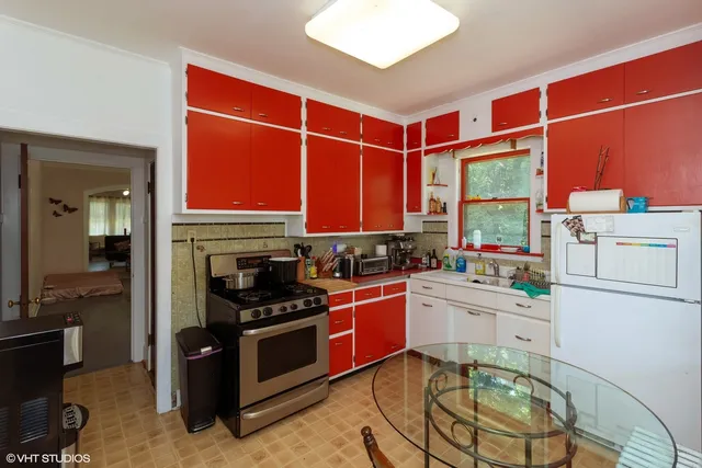 a kitchen with stainless steel appliances a stove a sink and a refrigerator