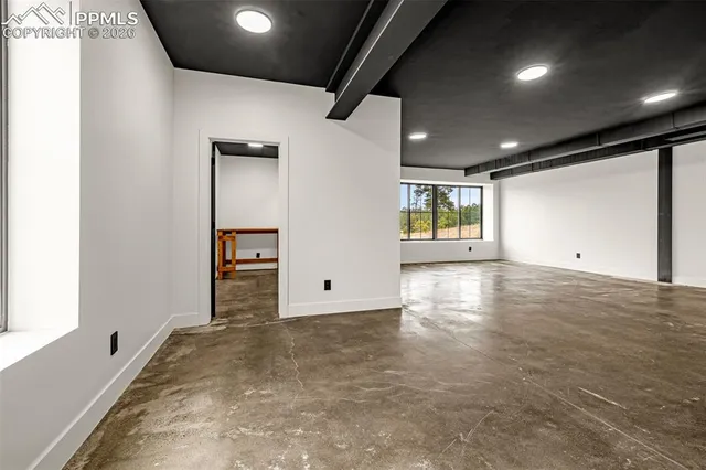 a view of a kitchen with wooden floor and a sink