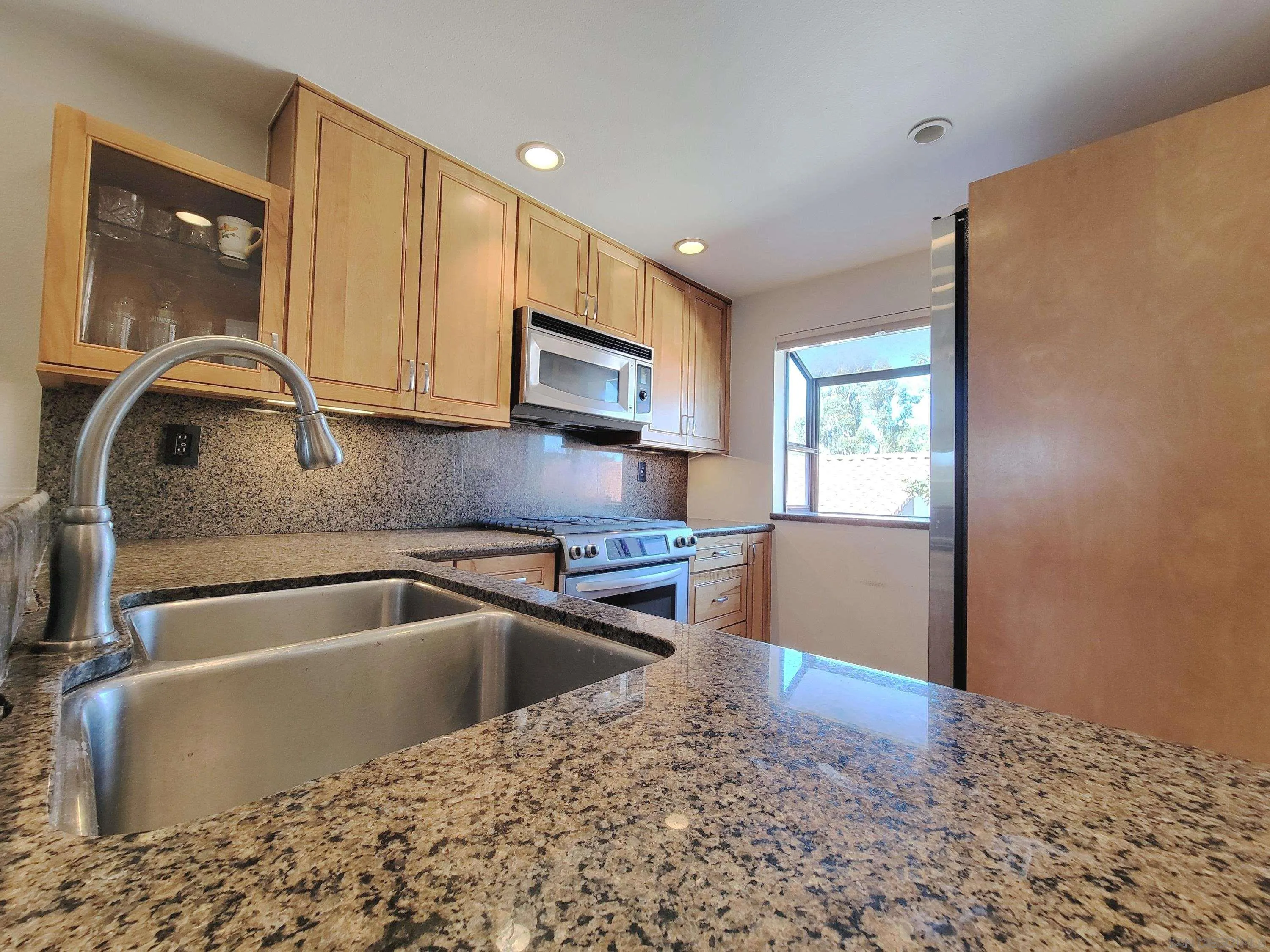 116 South Darien Drive Encinitas, CA 92024 - Photo 8 of 27 a kitchen with a sink cabinets and a microwave