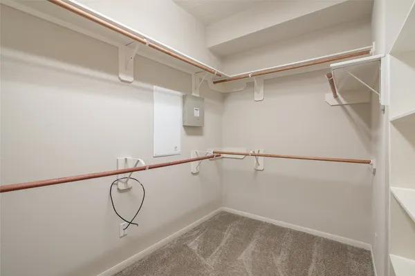 an empty room with closet and a ceiling fan