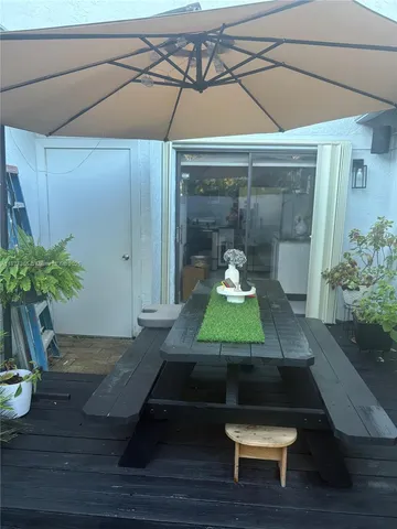 a room with wooden floor and potted plant