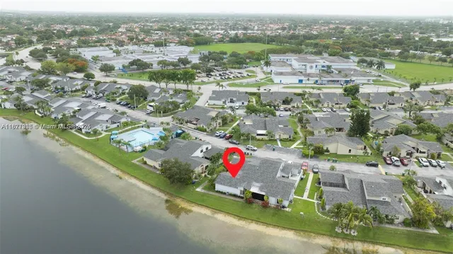 an aerial view of residential houses with outdoor space and river