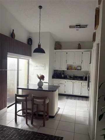 a kitchen with a table chairs and a window