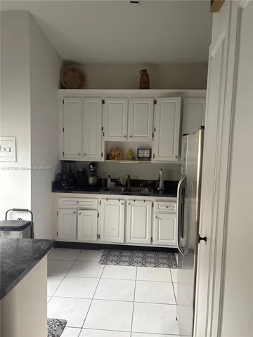 a kitchen with stainless steel appliances a refrigerator sink and cabinets