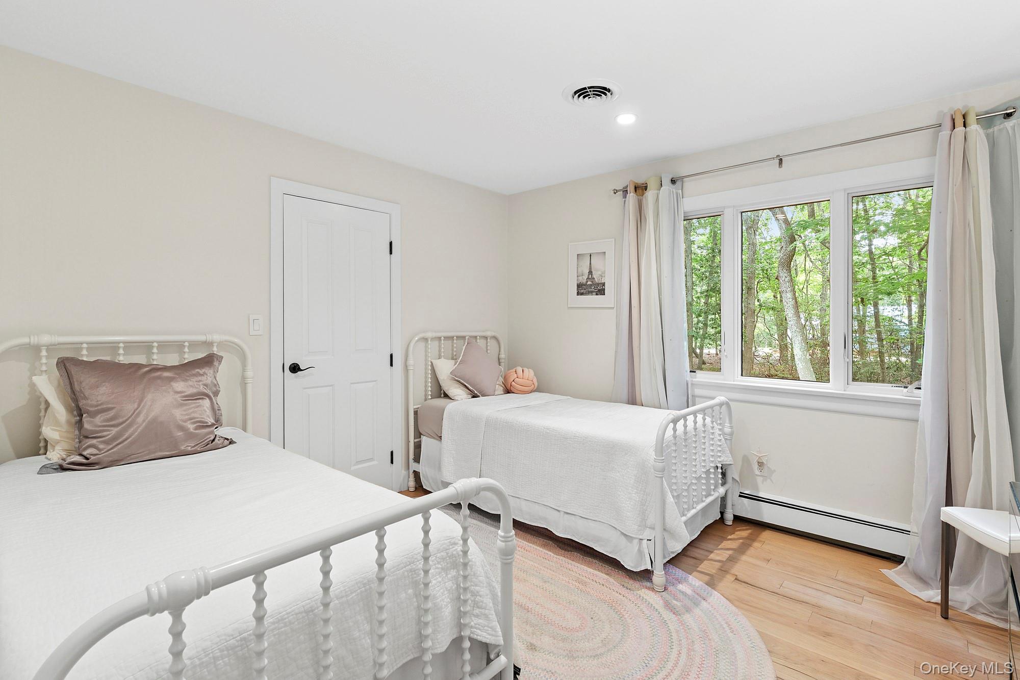 2723 Deerfield Road Sag Harbor, NY 11963 - Photo 11 of 22 a bedroom with a bed and a window