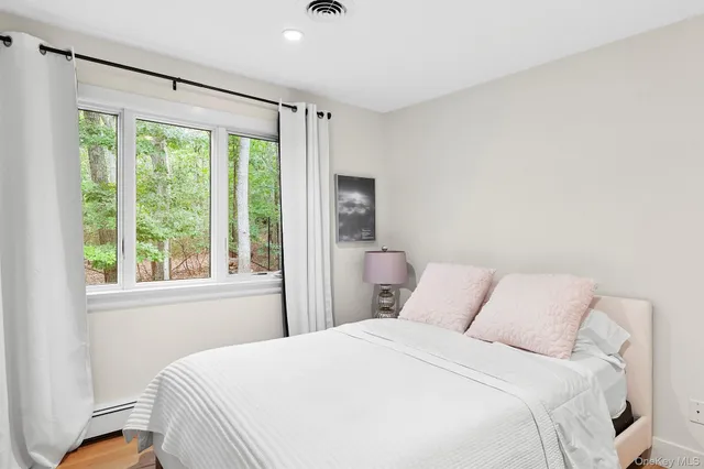 a bedroom with a large bed and a window