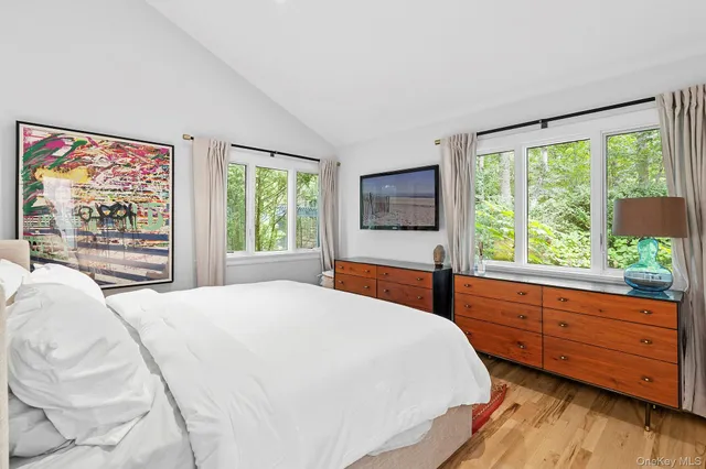 a bedroom with a bed and a large window