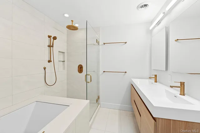 a bathroom with a granite countertop shower a sink and a mirror