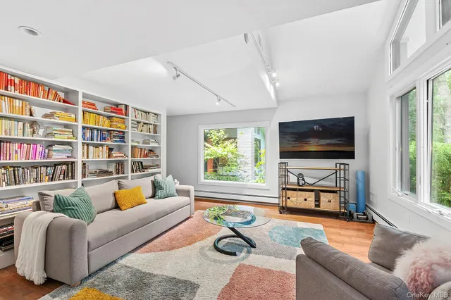 a living room with furniture workspace and a flat screen tv