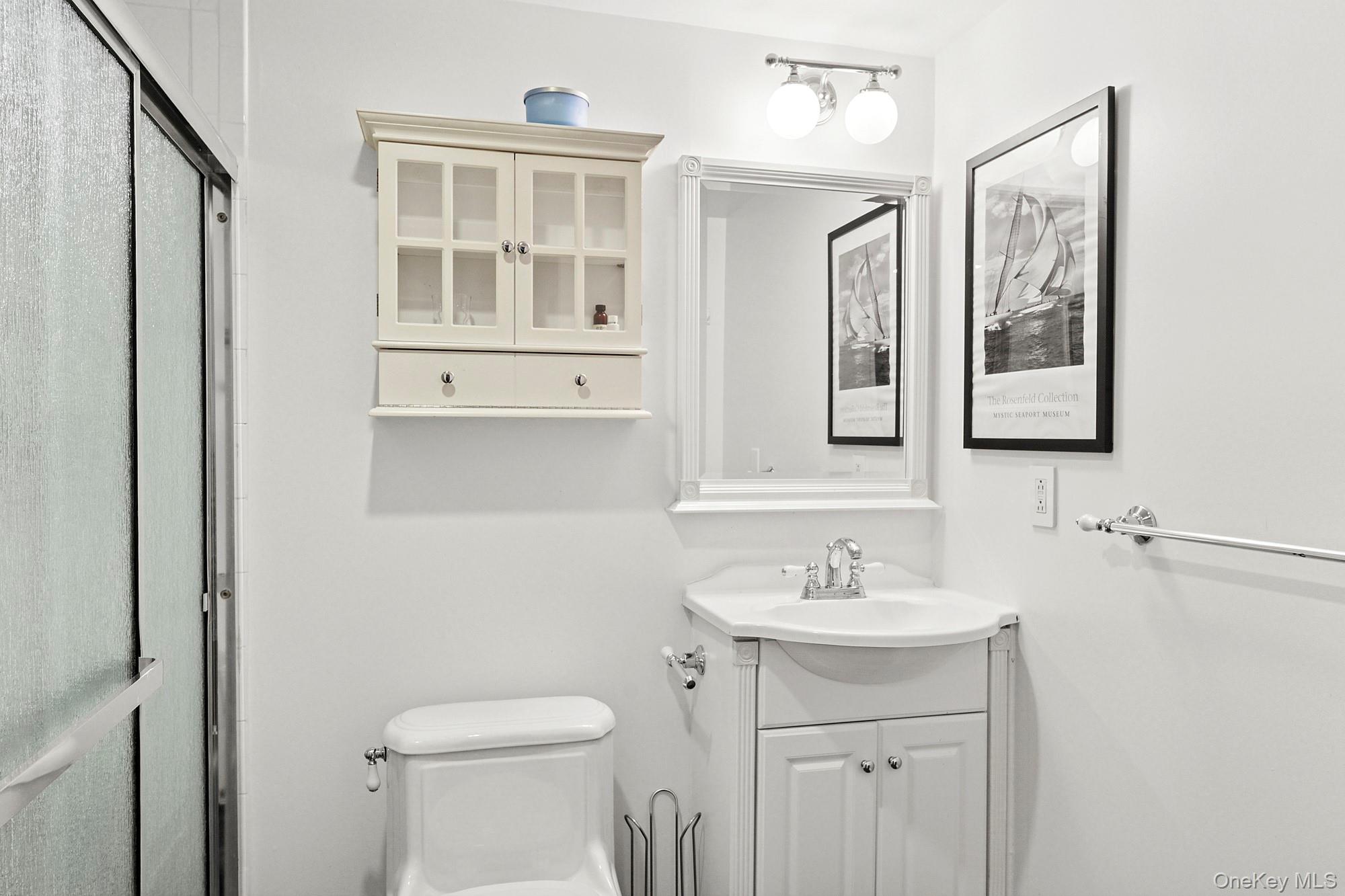 2723 Deerfield Road Sag Harbor, NY 11963 - Photo 17 of 22 a bathroom with a sink and a mirror