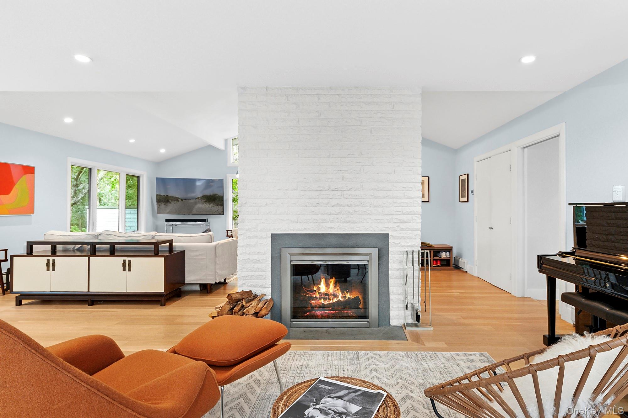 2723 Deerfield Road Sag Harbor, NY 11963 - Photo 3 of 22 a living room with furniture a fireplace a flat screen tv and a window