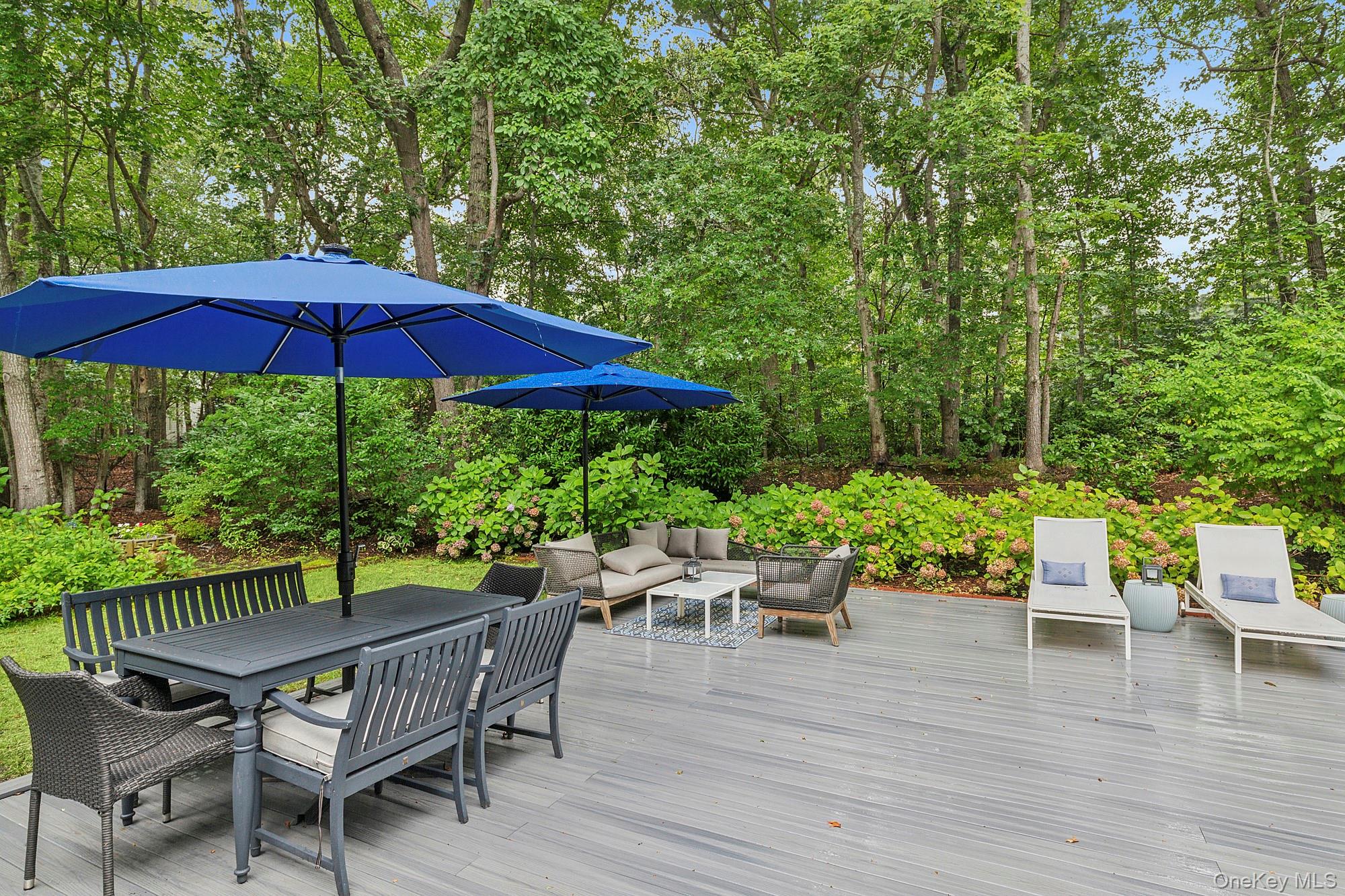 2723 Deerfield Road Sag Harbor, NY 11963 - Photo 6 of 22 an outdoor space with furniture and umbrella