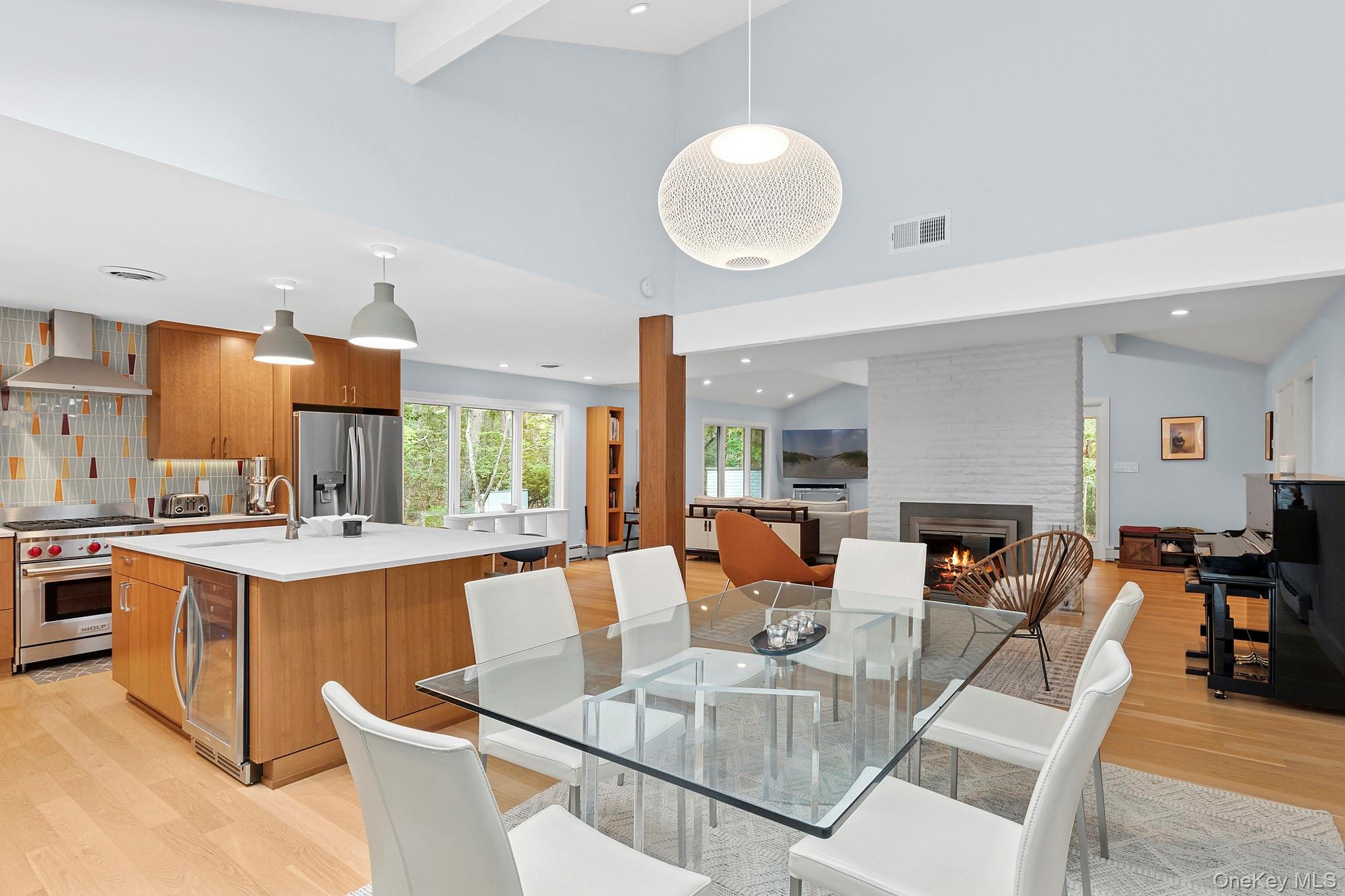 2723 Deerfield Road Sag Harbor, NY 11963 - Photo 9 of 22 a view of a dining room with furniture a fireplace and wooden floor