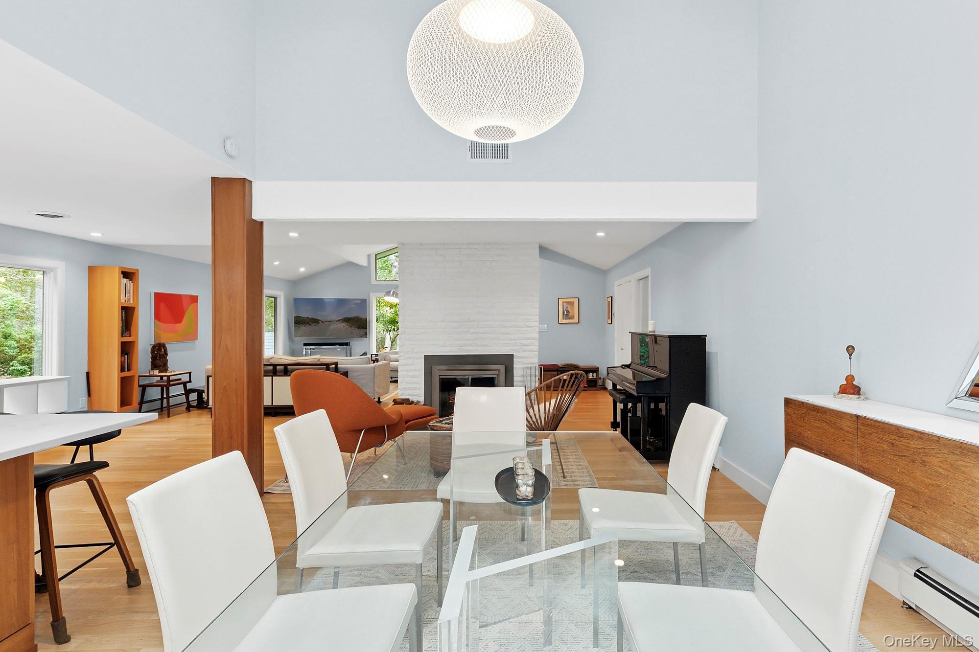 2723 Deerfield Road Sag Harbor, NY 11963 - Photo 10 of 22 a living room with furniture a fireplace and a large mirror