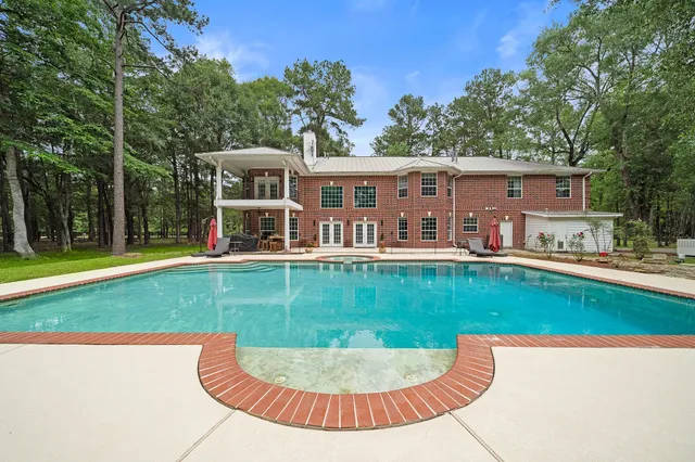 a view of a house with a backyard porch and sitting area