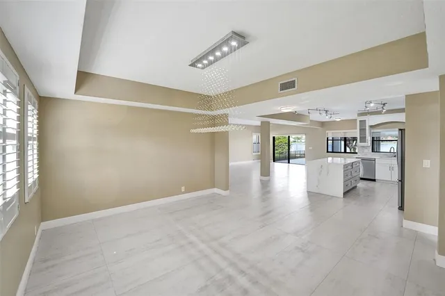 a view of empty room with wooden floor and windows