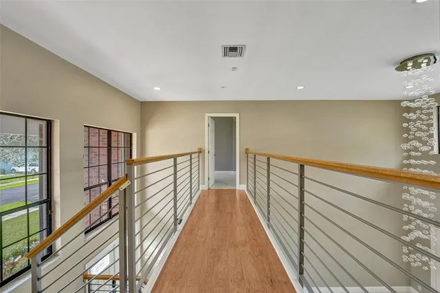 a view of a hallway with wooden floor