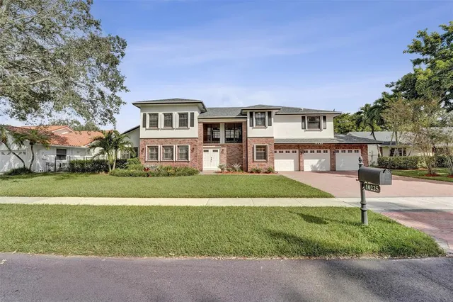 a front view of house with yard and green space