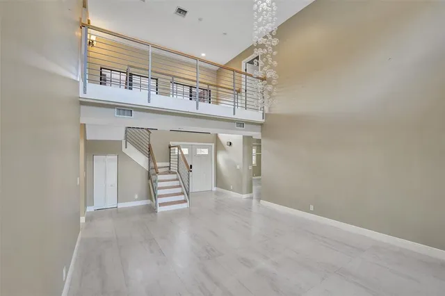 a view of an empty room with stairs and stairs