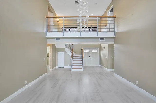 a view of a kitchen with a sink and wooden floor