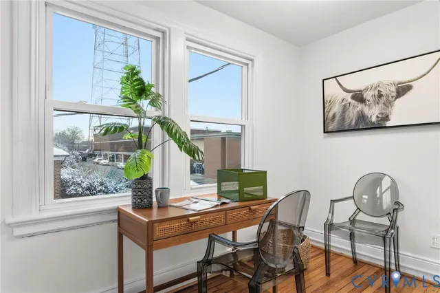 a workspace with furniture and a potted plant