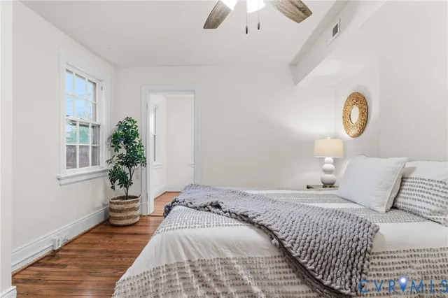 a bedroom with a bed and a potted plant