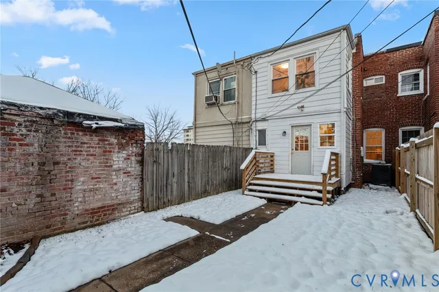 a view of a house with wooden fence