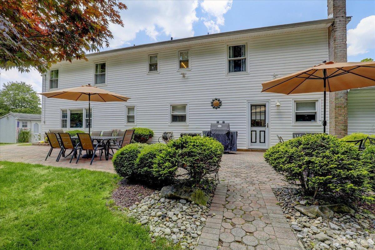 10 William Way Old Bridge, NJ 07747 - Photo 27 of 33 a view of a patio with table and chairs under an umbrella