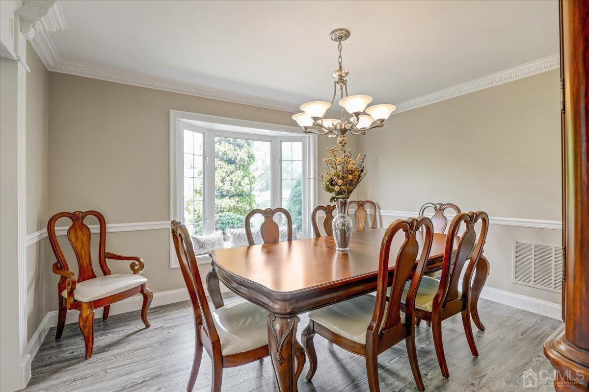 10 William Way Old Bridge, NJ 07747 - Photo 6 of 33 a dining room with furniture a chandelier and wooden floor