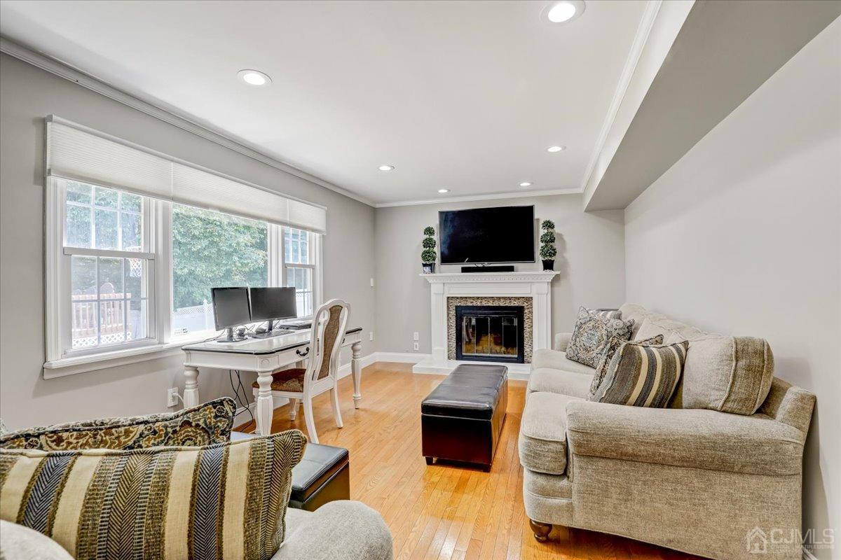 10 William Way Old Bridge, NJ 07747 - Photo 9 of 33 a living room with furniture a flat screen tv and a fireplace
