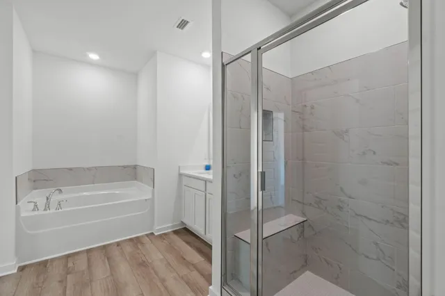 a bathroom with a bathtub and a shower