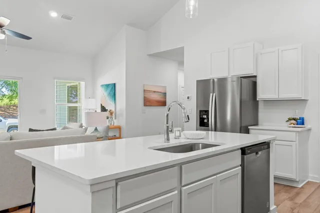 a kitchen with stainless steel appliances a sink and cabinets