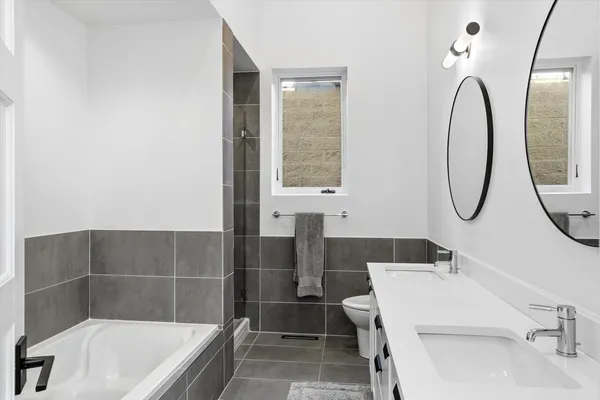 a spacious bathroom with a sink and a mirror