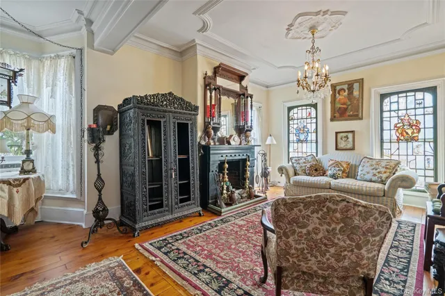 a living room with fireplace furniture and a chandelier