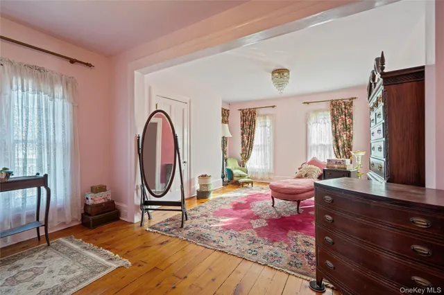 a living room with furniture a rug and a large window