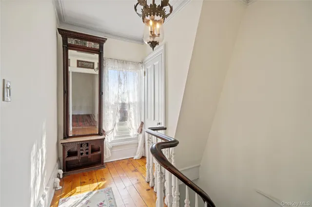 a view of a hallway with windows and stairs