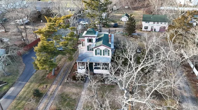 an aerial view of a houses with yard