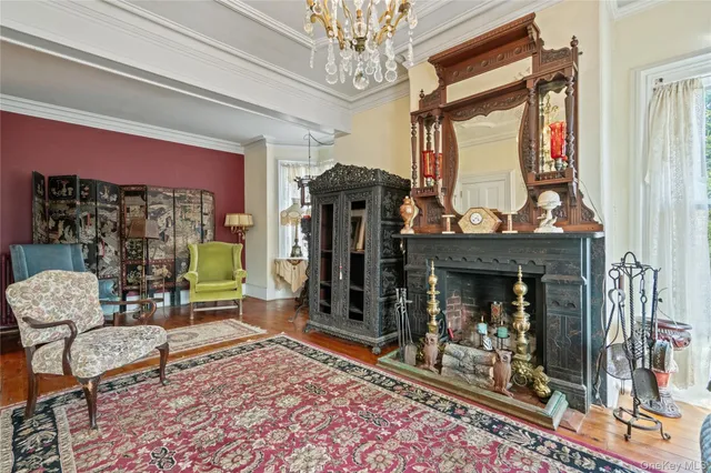 a living room filled with furniture and a chandelier