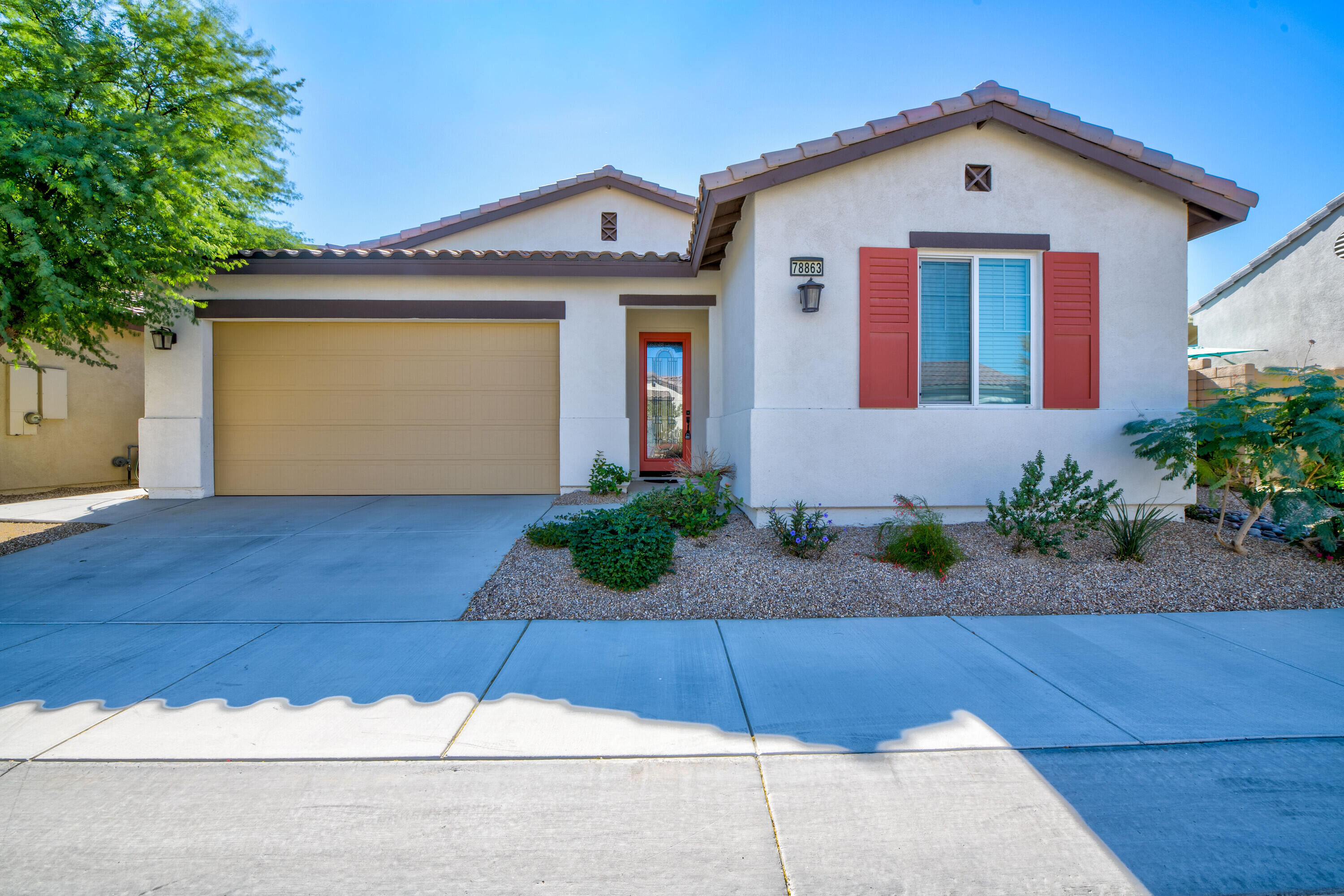 78863 Amare Way Palm Desert, CA 92211 - Photo 1 of 39 a front view of house with garage and yard