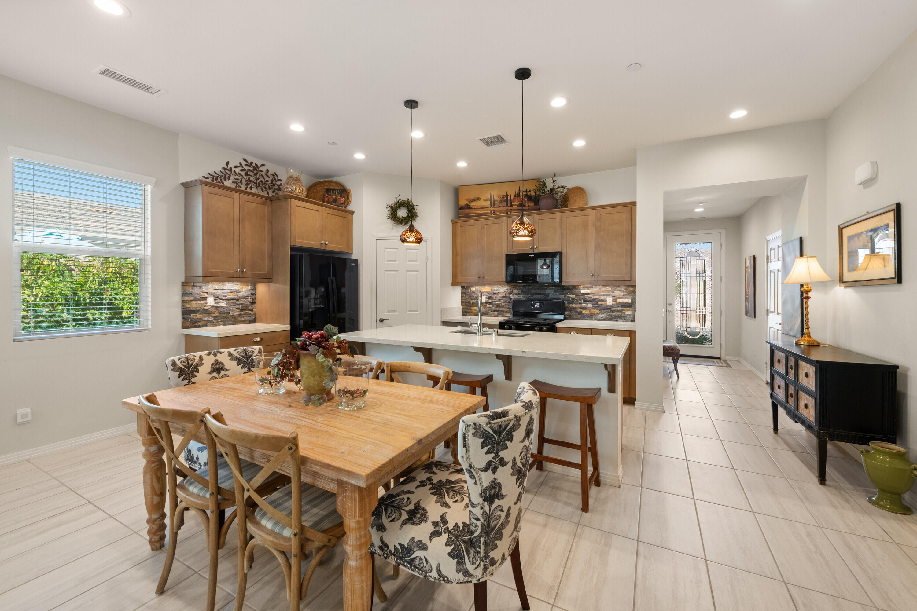 78863 Amare Way Palm Desert, CA 92211 - Photo 17 of 39 a kitchen with a dining table cabinets and appliances